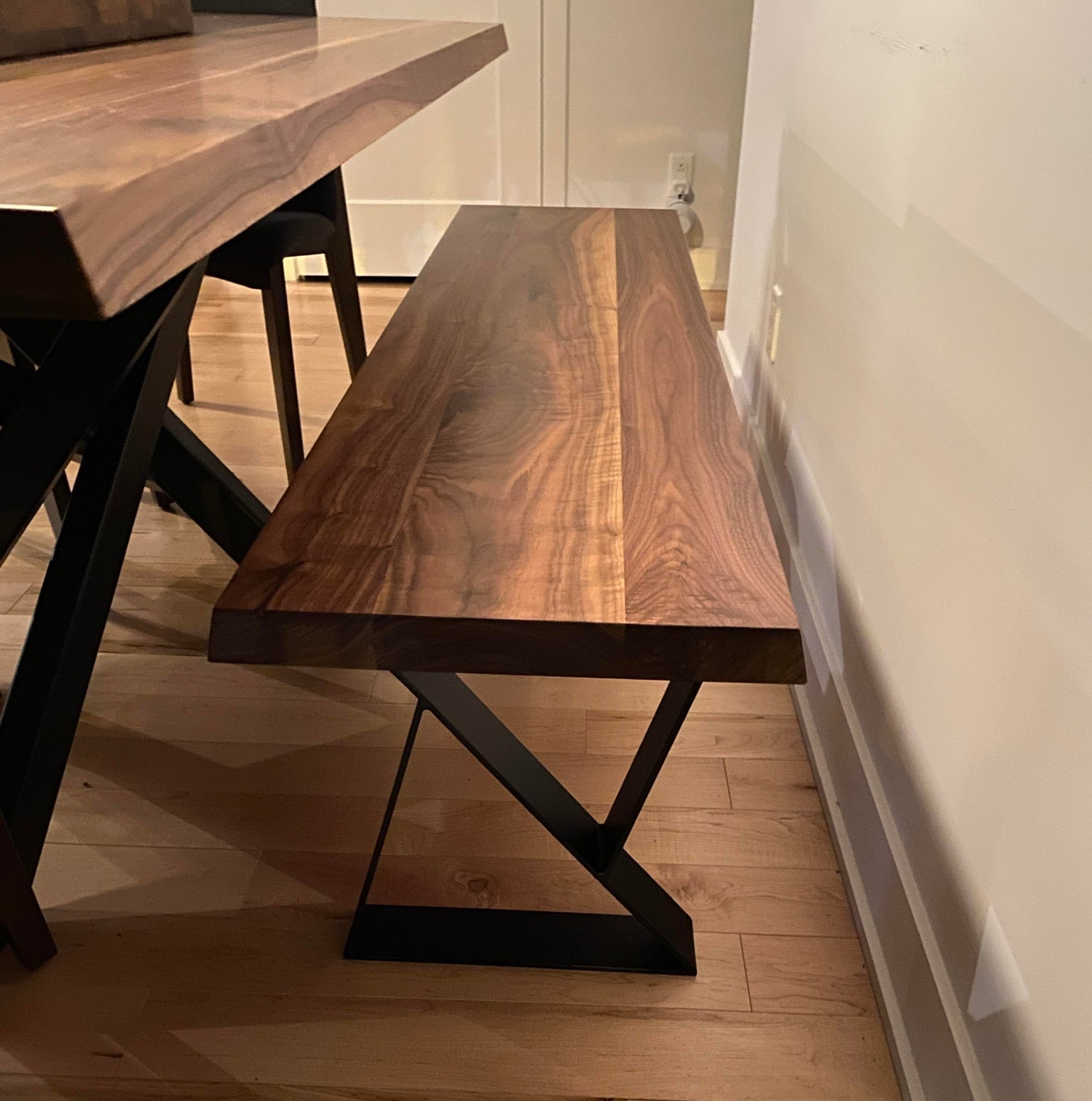 Gros plan sur un banc collection Roberval en noyer massif naturel